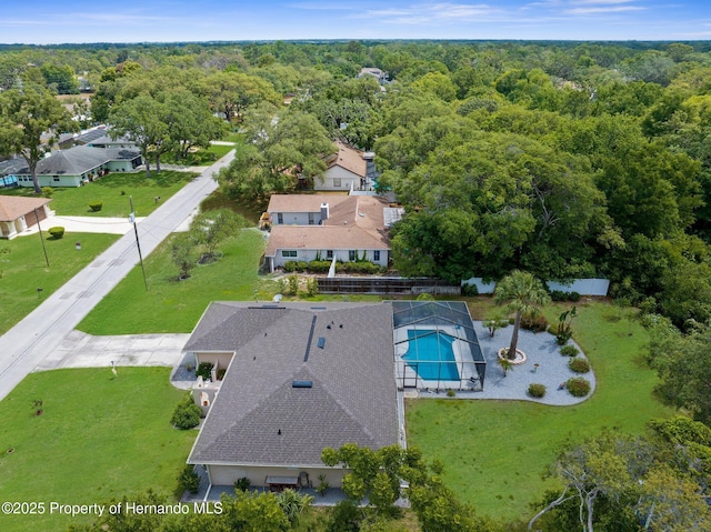 birds eye view of property with a view of trees