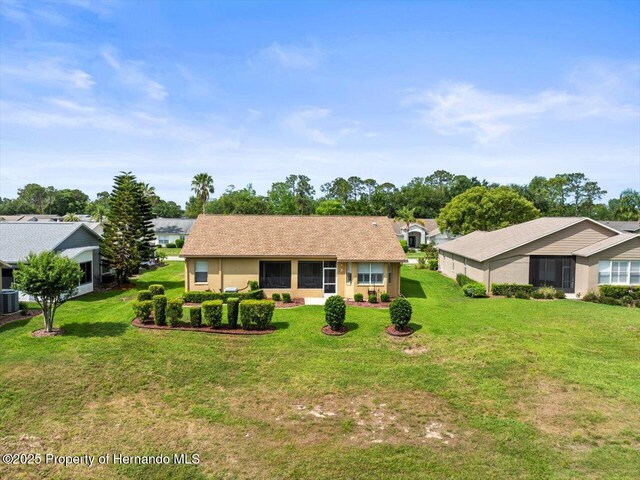 18514 Hidden Pines Way, Hudson, FL 34667 - view of front of home featuring central air condition unit and a front lawn