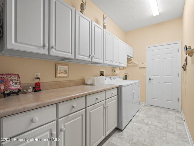 18514 Hidden Pines Way, Hudson, FL 34667 - clothes washing area with cabinet space, separate washer and dryer, baseboards, and a textured ceiling