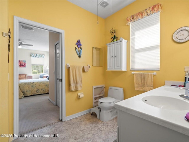 18514 Hidden Pines Way, Hudson, FL 34667 - bathroom with ceiling fan, toilet, connected bathroom, vanity, and baseboards