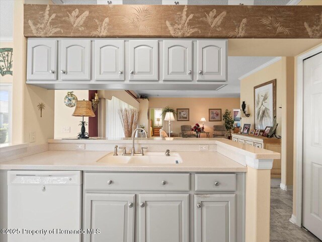 18514 Hidden Pines Way, Hudson, FL 34667 - kitchen featuring dishwasher, a sink, a peninsula, light countertops, and open floor plan