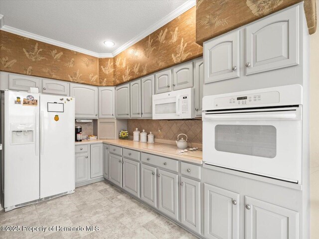 18514 Hidden Pines Way, Hudson, FL 34667 - kitchen with white appliances, gray cabinets, a textured ceiling, tasteful backsplash, and light countertops