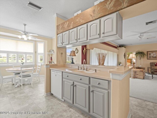18514 Hidden Pines Way, Hudson, FL 34667 - kitchen featuring a ceiling fan, dishwasher, a sink, a textured ceiling, and open floor plan