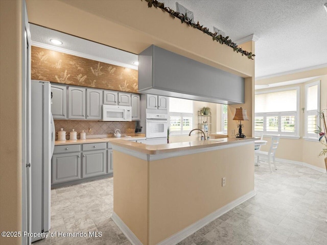 18514 Hidden Pines Way, Hudson, FL 34667 - kitchen featuring white appliances, gray cabinets, ornamental molding, light countertops, and tasteful backsplash