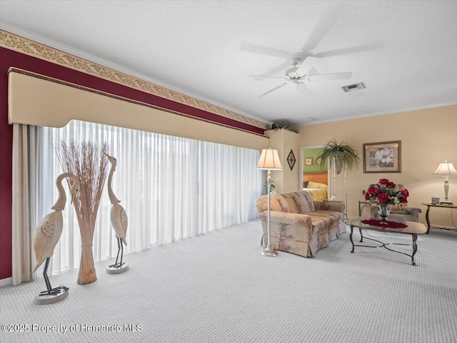 18514 Hidden Pines Way, Hudson, FL 34667 - carpeted living room featuring crown molding, ceiling fan, and a textured ceiling