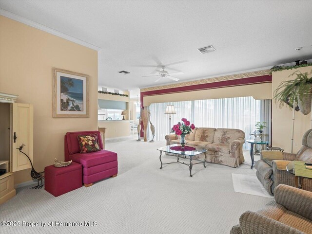 18514 Hidden Pines Way, Hudson, FL 34667 - living room with carpet floors, plenty of natural light, a ceiling fan, crown molding, and baseboards