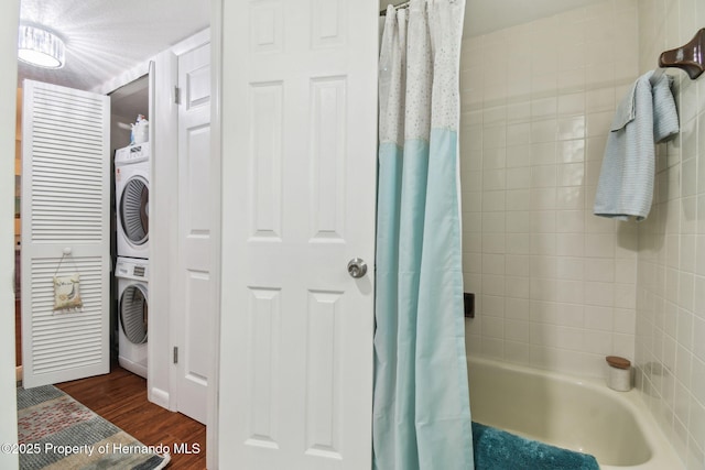 4008 Passport Ln, New Port Richey, FL 34653 - bathroom featuring stacked washer / dryer, wood finished floors, and shower / bath combo