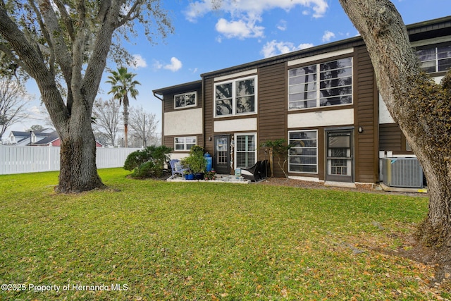 4008 Passport Ln, New Port Richey, FL 34653 - back of property featuring central AC and stucco siding