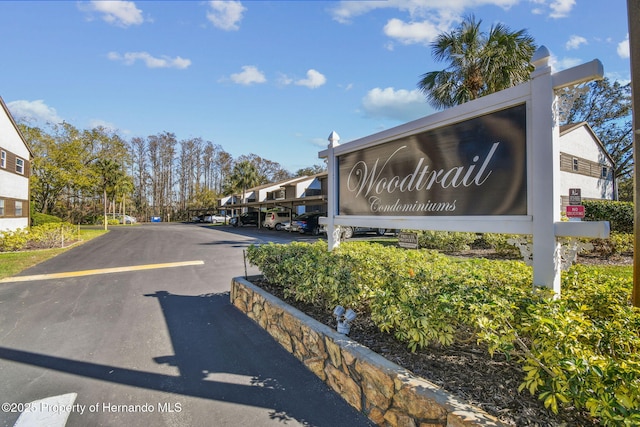4008 Passport Ln, New Port Richey, FL 34653 - community / neighborhood sign featuring covered and uncovered parking and a residential view