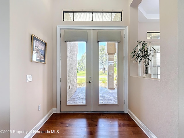 entryway featuring french doors, healthy amount of natural light, and wood finished floors
