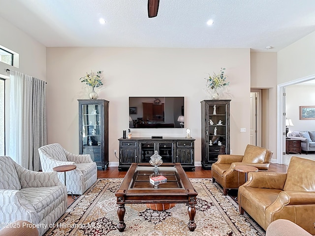 living area with wood finished floors, recessed lighting, and ceiling fan