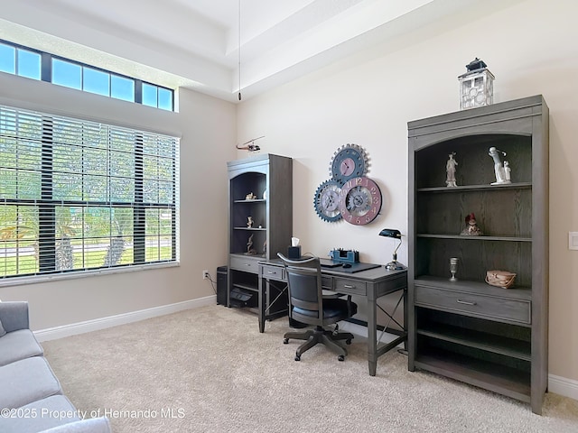 carpeted home office with baseboards