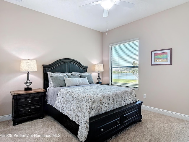 bedroom with light carpet, baseboards, and a ceiling fan