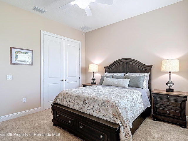 bedroom with light colored carpet, a closet, baseboards, and ceiling fan