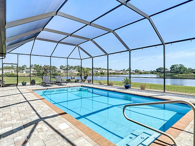 swimming pool featuring a patio area, a lanai, and a water view