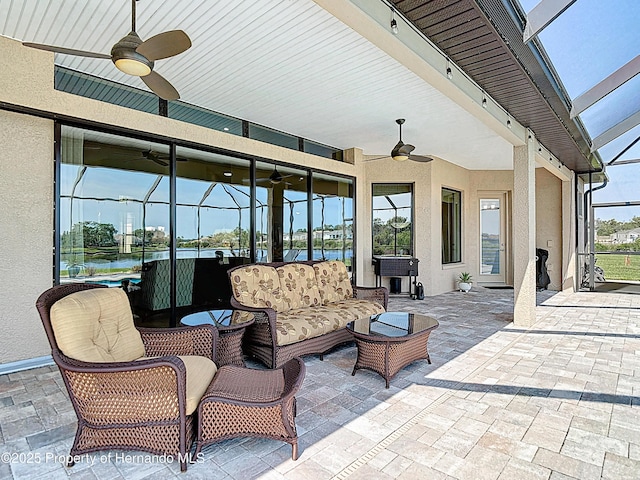 view of patio with a ceiling fan, an outdoor hangout area, and a lanai