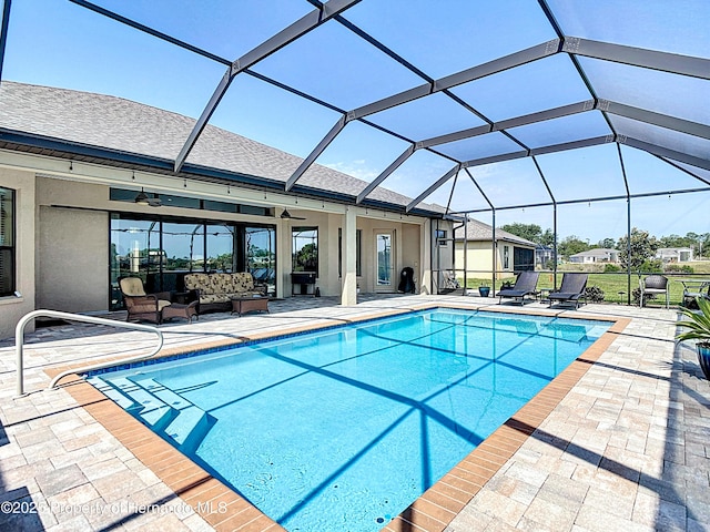 swimming pool featuring ceiling fan, outdoor lounge area, a patio, and a lanai