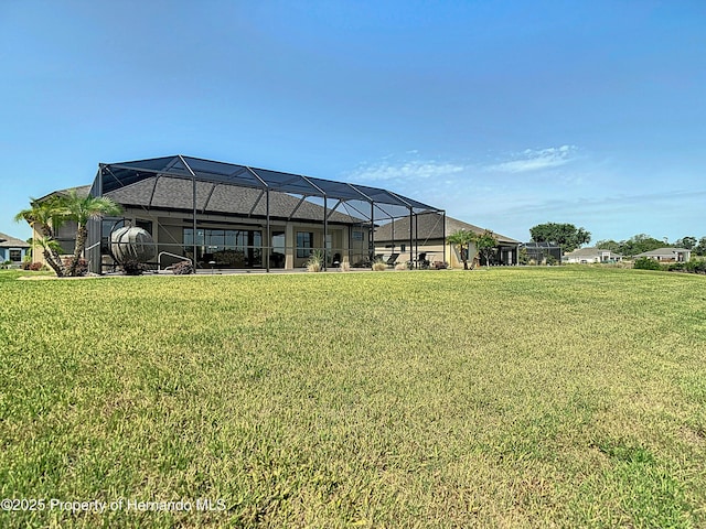view of green lawn with a lanai