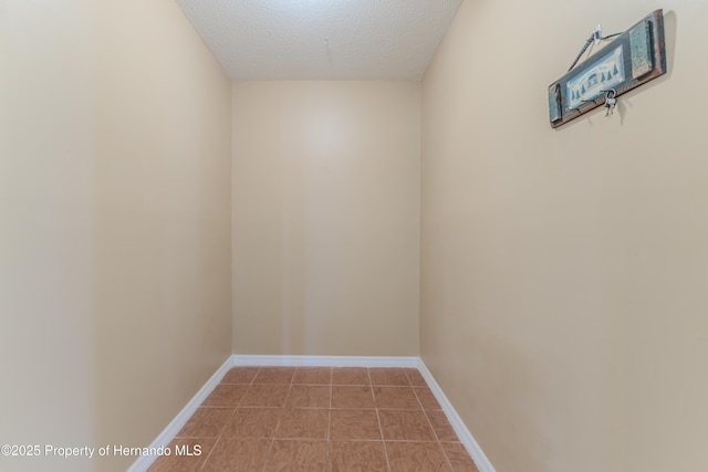 4446 San Juan Dr, Hernando Beach, FL 34607 - spare room featuring a textured ceiling and baseboards