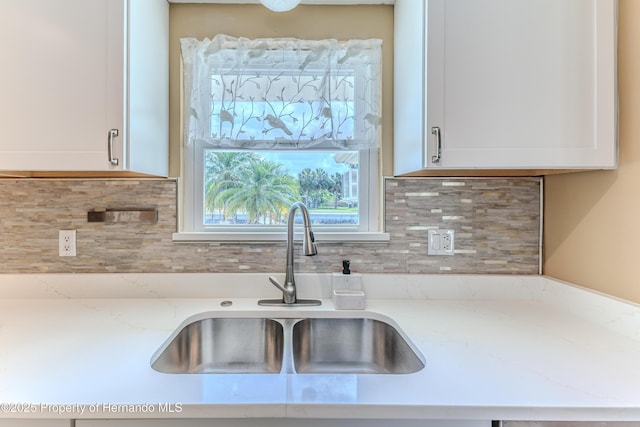 4446 San Juan Dr, Hernando Beach, FL 34607 - kitchen with a sink, white cabinets, tasteful backsplash, and light stone counters