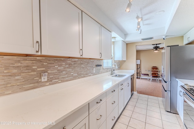 4446 San Juan Dr, Hernando Beach, FL 34607 - kitchen with a sink, appliances with stainless steel finishes, light tile patterned flooring, light countertops, and decorative backsplash