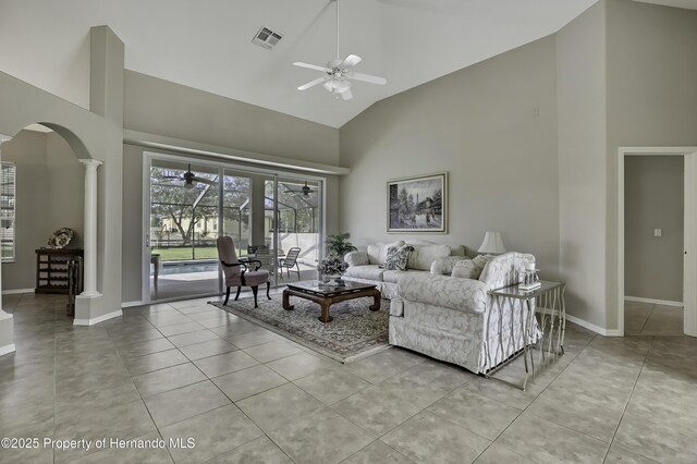 11336 Flower Ave, Weeki Wachee, FL 34613 - living room with a ceiling fan, ornate columns, high vaulted ceiling, visible vents, and arched walkways