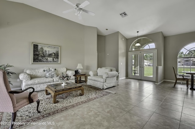 11336 Flower Ave, Weeki Wachee, FL 34613 - tiled living room with a ceiling fan, french doors, baseboards, visible vents, and high vaulted ceiling