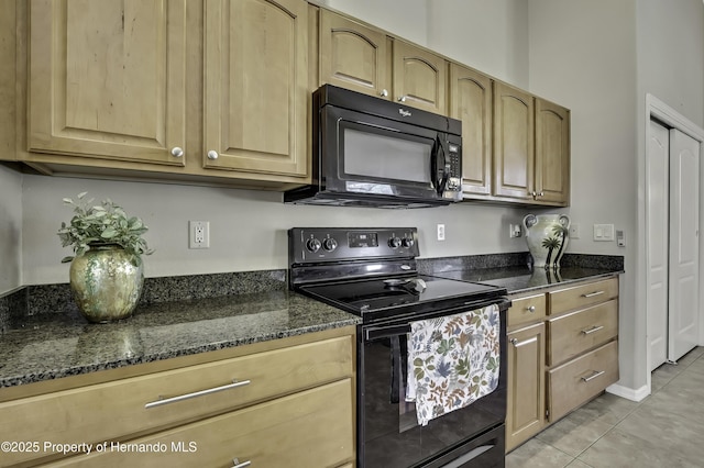11336 Flower Ave, Weeki Wachee, FL 34613 - kitchen featuring dark stone counters, light tile patterned floors, and black appliances