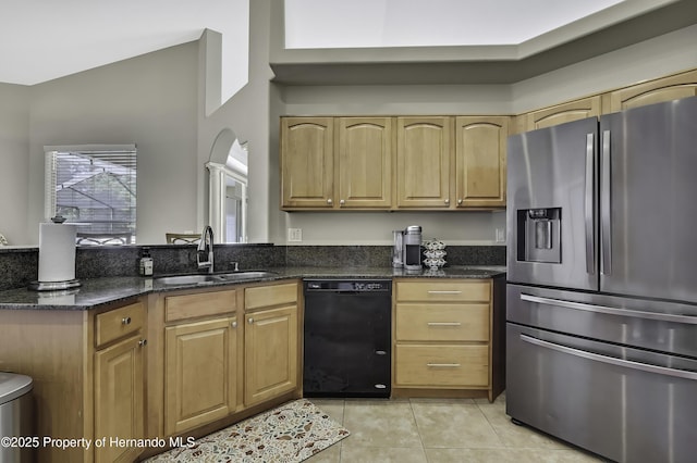 11336 Flower Ave, Weeki Wachee, FL 34613 - kitchen featuring light tile patterned floors, a sink, dark stone counters, black dishwasher, and stainless steel fridge with ice dispenser