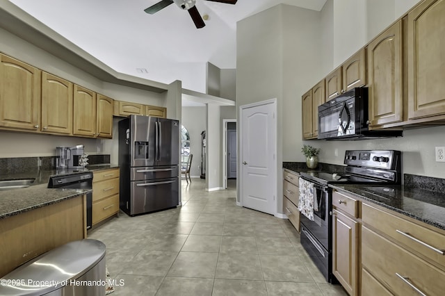 11336 Flower Ave, Weeki Wachee, FL 34613 - kitchen featuring a ceiling fan, light tile patterned floors, a towering ceiling, black appliances, and dark stone counters