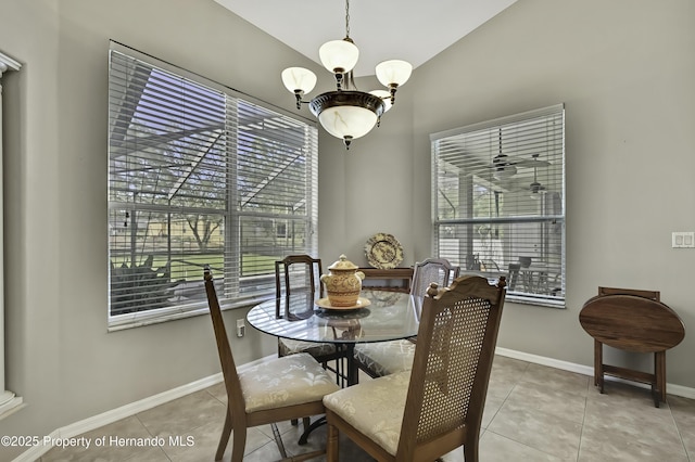 11336 Flower Ave, Weeki Wachee, FL 34613 - dining space with light tile patterned floors, baseboards, plenty of natural light, and vaulted ceiling