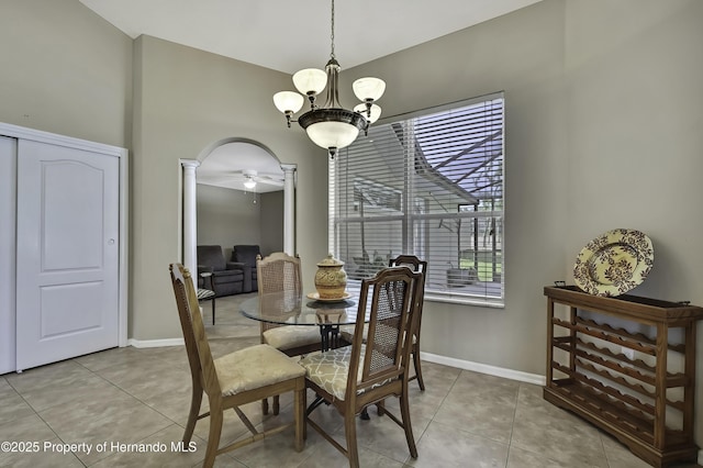 11336 Flower Ave, Weeki Wachee, FL 34613 - dining space with light tile patterned floors, baseboards, an inviting chandelier, and decorative columns
