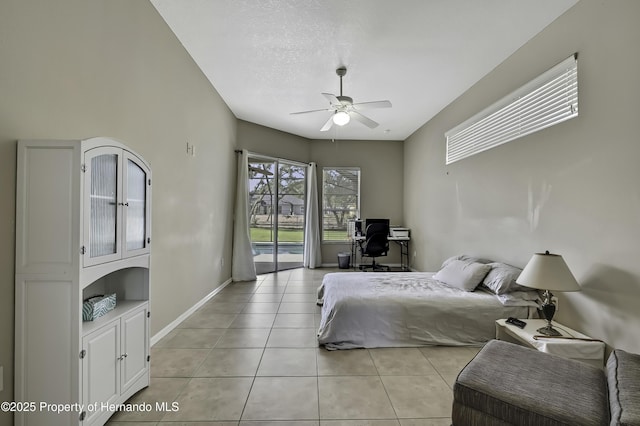11336 Flower Ave, Weeki Wachee, FL 34613 - bedroom with a ceiling fan, light tile patterned floors, baseboards, and access to exterior