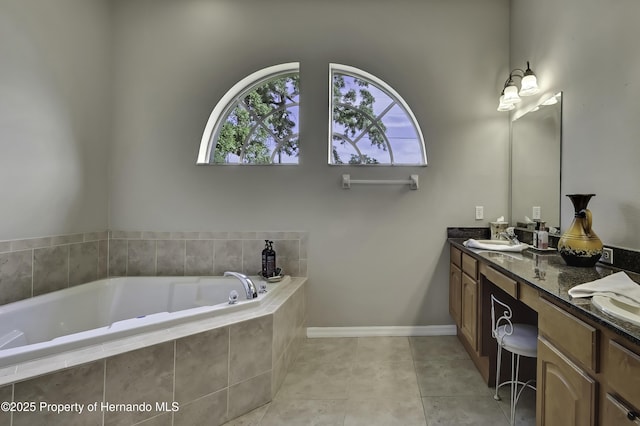 11336 Flower Ave, Weeki Wachee, FL 34613 - full bathroom with baseboards, a bath, a sink, tile patterned floors, and double vanity