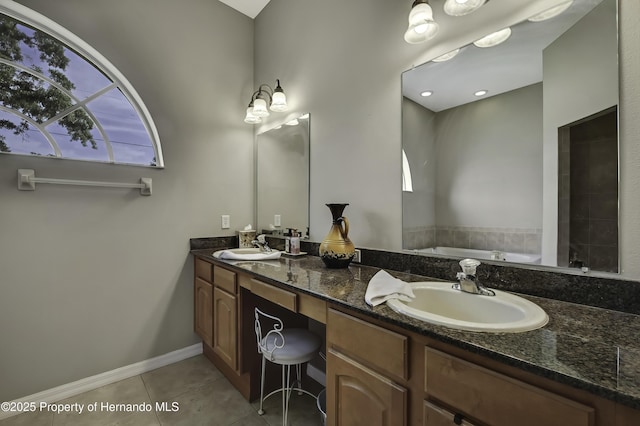 11336 Flower Ave, Weeki Wachee, FL 34613 - full bathroom featuring a sink, tile patterned flooring, double vanity, and a garden tub