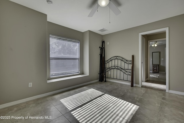 11336 Flower Ave, Weeki Wachee, FL 34613 - unfurnished bedroom featuring baseboards, a ceiling fan, visible vents, and tile patterned floors