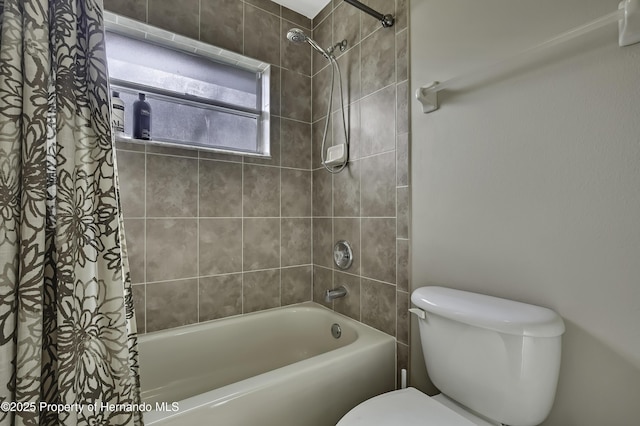 11336 Flower Ave, Weeki Wachee, FL 34613 - bathroom featuring shower / bathtub combination with curtain and toilet
