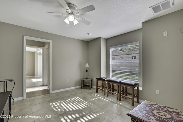 11336 Flower Ave, Weeki Wachee, FL 34613 - interior space with baseboards, ceiling fan, visible vents, and a textured ceiling