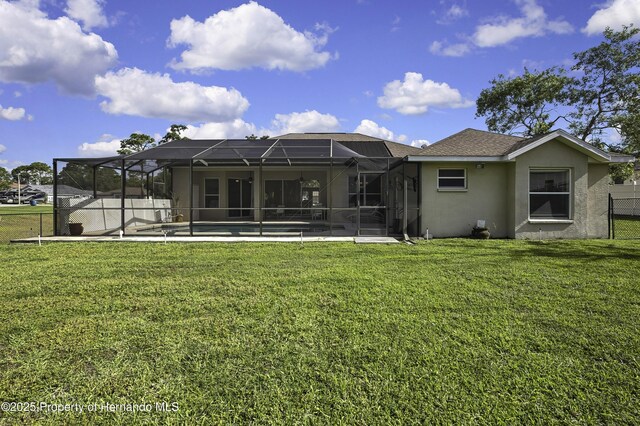 11336 Flower Ave, Weeki Wachee, FL 34613 - back of house featuring a yard, stucco siding, a fenced in pool, and fence
