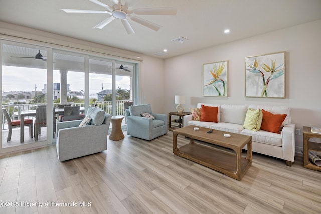 living room featuring a ceiling fan, light wood-type flooring, and recessed lighting