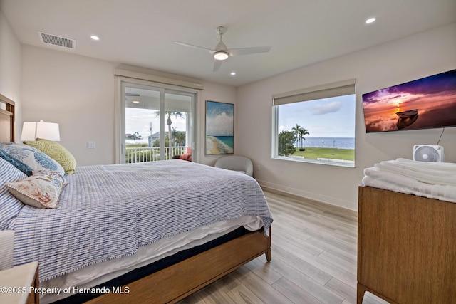 bedroom with access to outside, multiple windows, light wood finished floors, baseboards, and recessed lighting