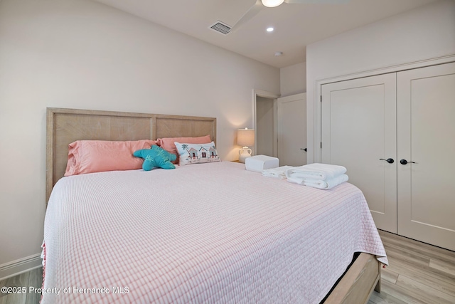 bedroom featuring light wood-type flooring, a closet, and recessed lighting