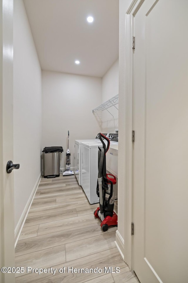 laundry area with separate washer and dryer, recessed lighting, and baseboards
