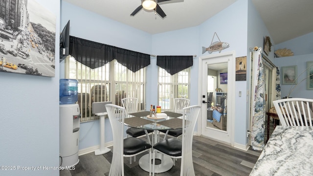 dining room featuring ceiling fan, wood finished floors, baseboards, and vaulted ceiling