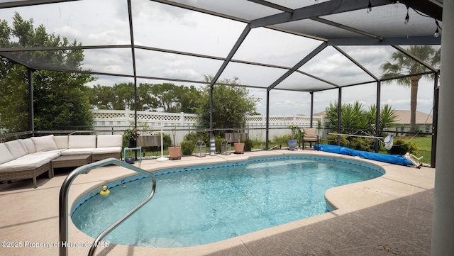 view of pool featuring a patio, fence, outdoor lounge area, and glass enclosure