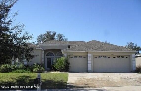 4301 Blakemore, Spring Hill, FL 34609 - ranch-style home featuring a garage and concrete driveway
