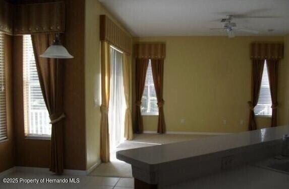 4301 Blakemore, Spring Hill, FL 34609 - bathroom featuring a ceiling fan, baseboards, and tile patterned floors