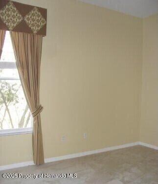 4301 Blakemore, Spring Hill, FL 34609 - spare room with healthy amount of natural light and baseboards