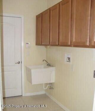 4301 Blakemore, Spring Hill, FL 34609 - clothes washing area with cabinet space, hookup for a washing machine, and baseboards