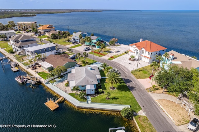 aerial perspective of suburban area with a nearby body of water